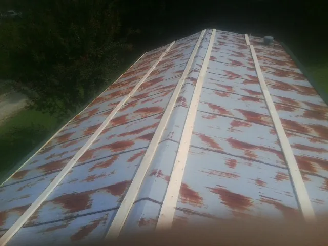 Rusted metal roof panels with new wood purlins before replacement — Storm Damage Roof Repair in Lake Bluff by Roofing Brothers