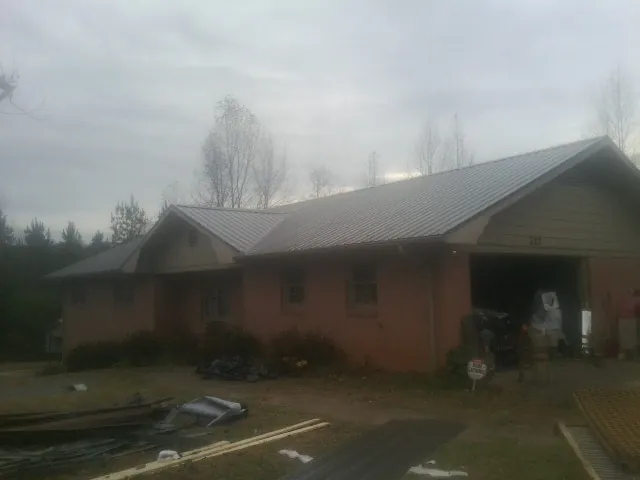 Gray metal roof on a stucco house with an attached garage in Lake Bluff